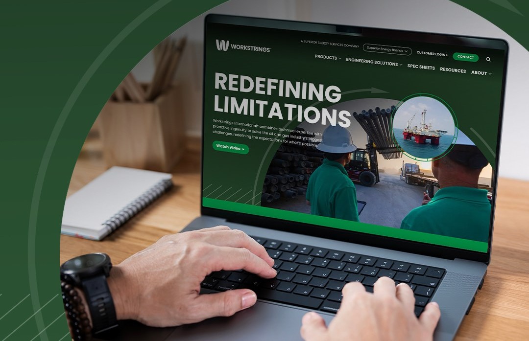 An over the shoulder view of a laptop computer with the new Workstrings website on the screen