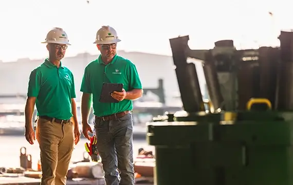 Two Workstrings employees checking over the quality of a FASTR® system before its loaded for transport