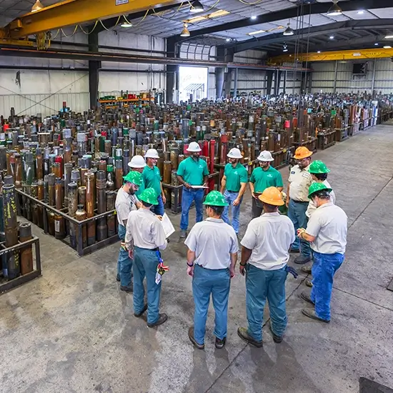 Workstrings warehouse workers gathered around together in a group huddle