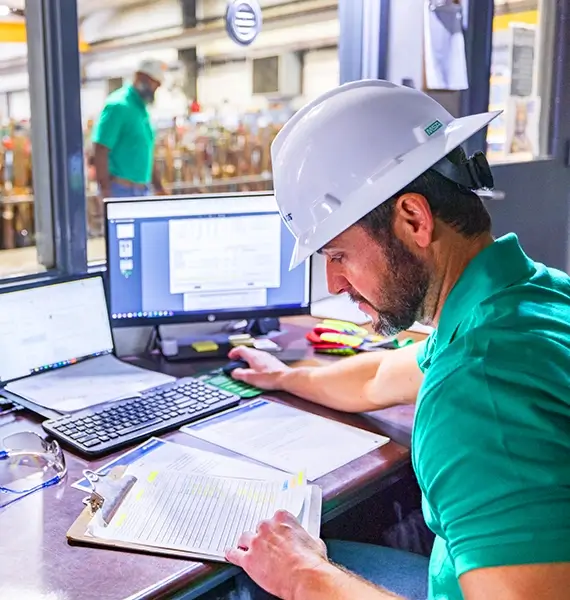 A Workstrings engineer looking over slip crushing calculations and inputting them into his computer