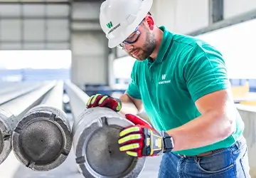 A Workstrings worker looking over heavy landing string casings