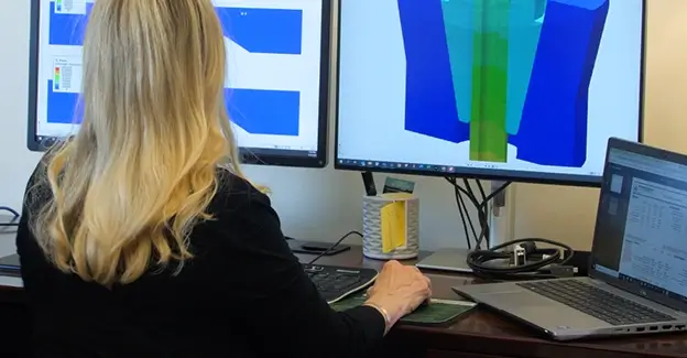 A Workstrings engineer going over specialty tool designs on her dual monitors