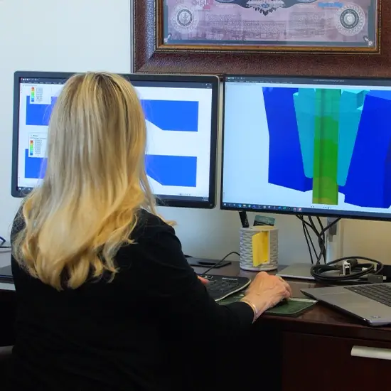 A Workstrings engineer going over specialty tool designs on her dual monitors