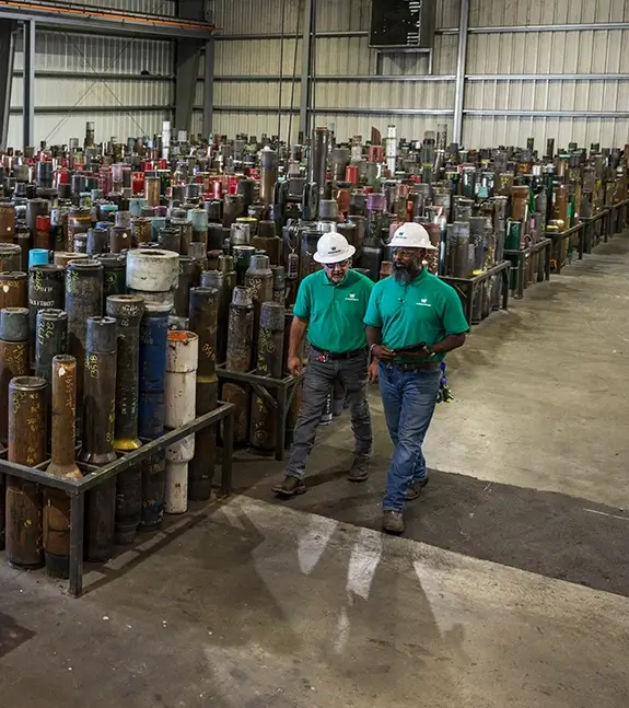 Two Workstrings workers walking through a warehouse talking