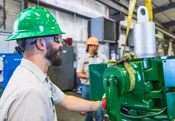 Two Workstrings workers smiling while hoisting a FASTR® system