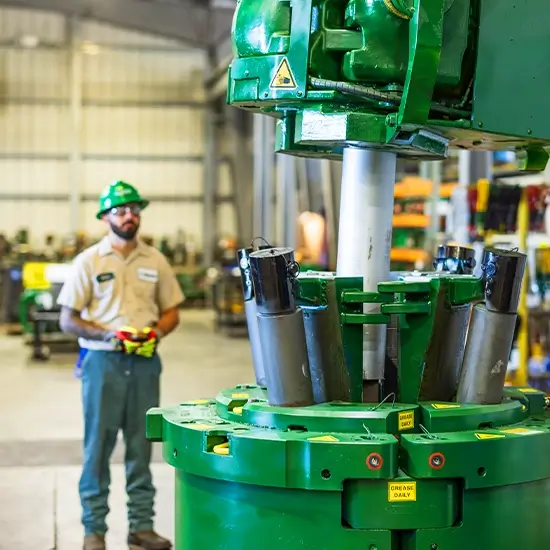 A Workstrings worker in a green helmet looking at the FASTR System