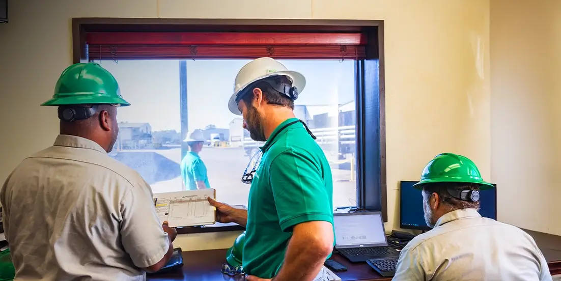 Workstrings workers looking over documents by a window