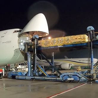 A plan being loaded with downhole equipment through the nose of the plane
