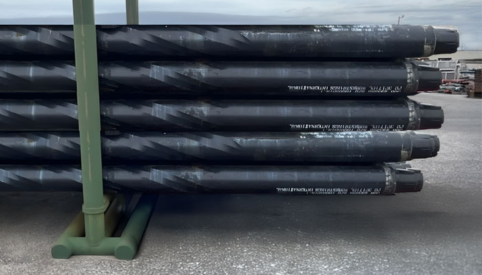 Black drill collars designed by Workstrings stacked on a rack 