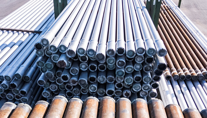 Drill pipes designed by Workstrings lined up on racks outside