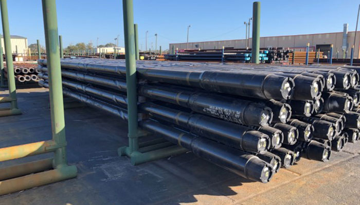 Heavy weight drill pipes designed by Workstrings lined up on racks outside