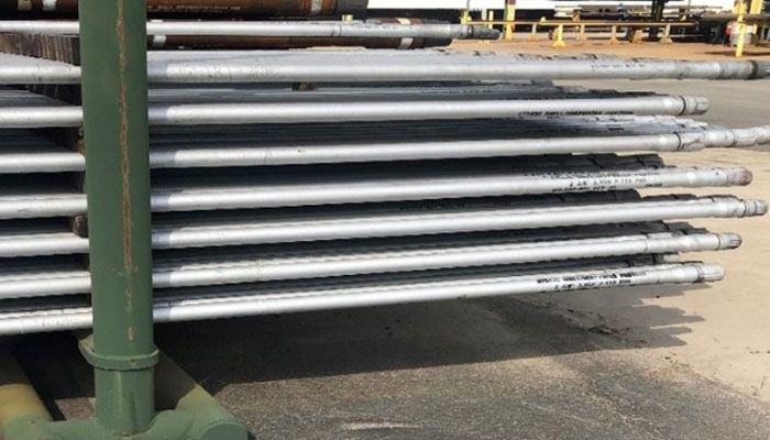 Workstrings's tubing resting on racks outside of a warehouse
